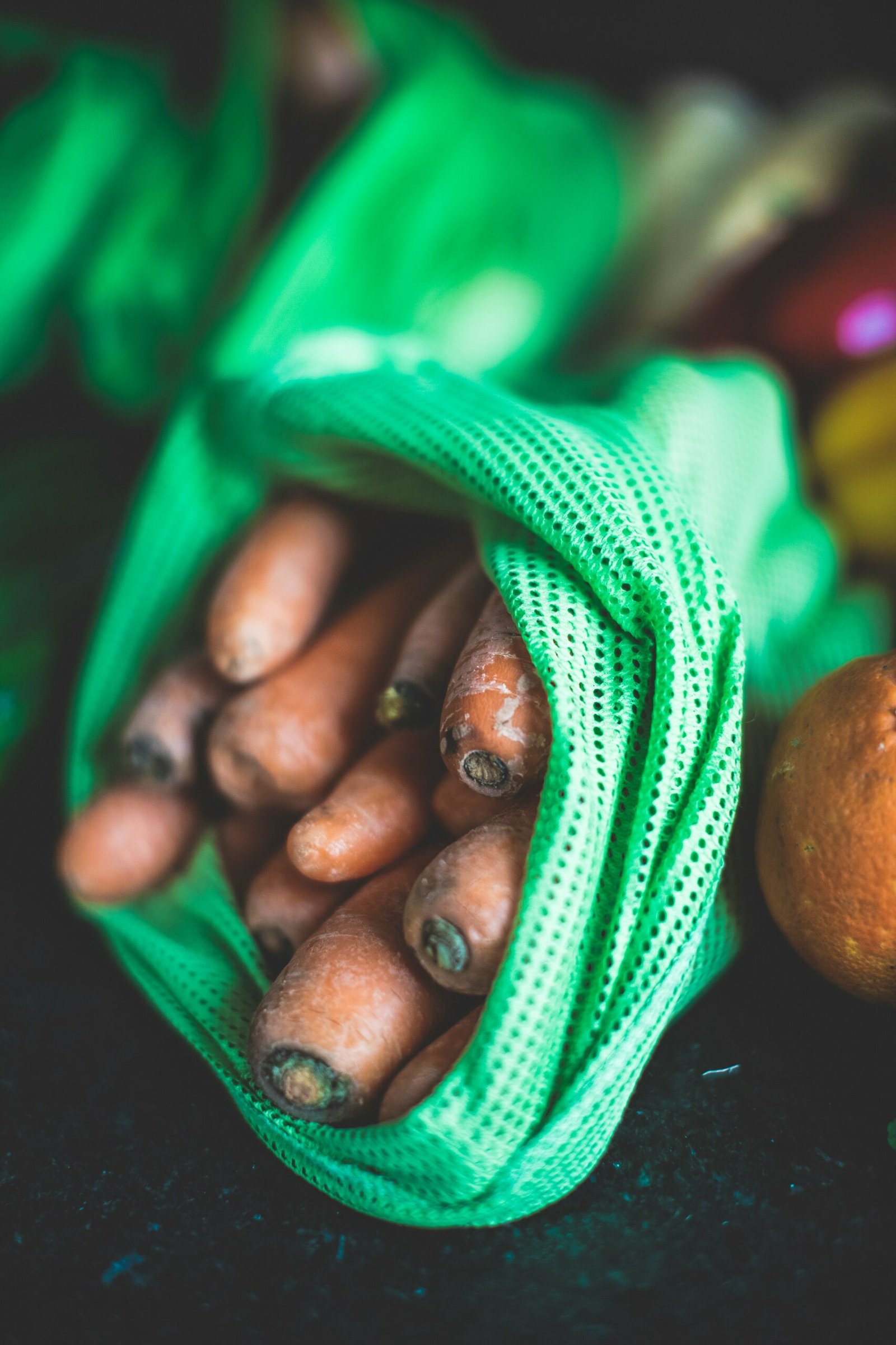 brown round fruit on green textile